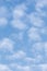 Bright light sky cloudscape background, sunny summer day clouds, vertical copy space