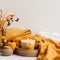 Bright light yellow and white cozy autumn interior decor arrangement, fall home decorations with candles and warm