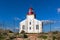 Bright Lighthouse beyond chain link fence