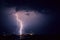 Bright lightning bolt with side branches strikes down in lake IJsselmeer, The Netherlands