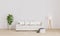 Bright living room for mockup with white sofa, white modern lamp, plant.  Furnished living room with white wall and wooden floor.