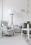 Bright living room with a white armchair and lamp