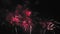 Bright magenta colored fireworks against the dark night sky