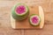 Bright magenta and green watermelon radish o a cutting board