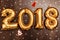 Bright metallic gold balloons figures 2018, Christmas, New Year Balloon with glitter stars on dark wood table background