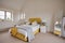 Bright modern furnished bedroom in yellow and white
