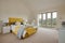 Bright modern furnished bedroom in yellow and white with teatray