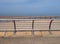 Bright modern metal railings along the seaside promenade in blackpool lancashire with concrete sea wall with ocean and blue sky