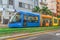 Bright modern moving tram with multicolor carriages on the street of Santa Cruz