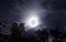 Bright moon on fall night with clouds and foliage