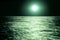 Bright moon green over the sea at night. moonlight on the waves, horizon. Long exposure