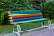 Bright multi-color pencil rainbow bench in park