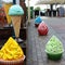 Bright multi-colored decorative cupcakes near a street cafe