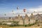 Bright multi-colored hot air balloons flying in sunsrise sky