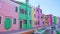 Bright multi-colored houses stand in row along water channel