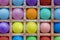 Bright multi-colored round balloons in square niches from styrofoam close up in a dash. rough surface texture
