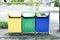 Bright multi-colored rubbish bins. Separate waste bins. Conceptual image of environmental pollution