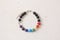 Bright multicolored bracelet made of precious stones on hand from natural stone. Handmade jewelry bracelets on light modern