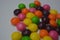 Bright multicolored and colored balls, sweet and tasty sweets, candies scattered on a white background.