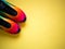 Bright multicolored sneakers on a yellow background. flat lay