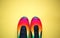 Bright multicolored sneakers on a yellow background. flat lay