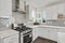 Bright and neutral kitchen with glossy gray subway tile backsplash