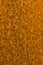 Bright ocher background or wallpaper. Vertical textured backdrop. Rough matte surface. A toned shot of rusty iron. Rich, juicy,