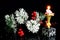Bright old Christmas candle, a symbol of Faith, Hope, Love and elegant Winter snow-covered spruce branch with a cone, a