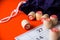 On a bright orange background, a board game of lotto, barrels, game cards and a bag for barrels, some objects are out of focus