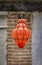 Bright orange blown Murano glass street light hanging outside in a street in Venice, Italy