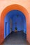 Bright orange colored doorway leading to vivid blue chapel, Monastery of Santa Catalina, Arequipa, Peru
