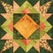 Bright orange-green geometric patchwork block from pieces of fabrics