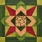 Bright orange-green geometric patchwork block from pieces of fabrics, detail of quilt