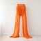 Bright Orange Knit Pants: A Dramatic Still Life In White Space