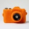 Bright Orange Knitted Camera Case: Quirky Elegance In Still Life Photography
