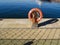 Bright orange life boat at commercial fishing harbor dock