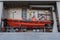 A bright orange lifeboat on an army warship. Riga, Latvia - 30 Oct 2022