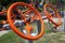 Bright orange metal steering wheels simulators on the playground