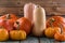 Bright orange pumpkins and butternut squashes on blue wooden tab