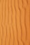 Bright orange rippled desert sand pattern for a warm summer background