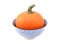 Bright orange sugar pumpkin in a blue and white bowl