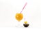 Bright orange sunny cocktail tube and two exotic fruit and yellow melon on skewers pitah eco bowl