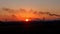 Bright orange sunset in an industrial city. dark outlines, silhouettes of smoking factory chimneys against a red sunset