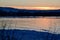 Bright orange sunset over Collingwood Harbour and vibrant reflections on water surface