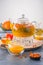 A bright orange teapot on a white background