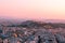 Bright panorama of Athens at sunset, red pink sky and ancient city