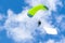 Bright parachutist on the background of blue sky