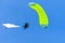 Bright parachutist on the background of blue sky
