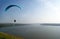 Bright paraglider, paragliding, sport, flying over a river, soar in the sky, aerial view, rocky coast