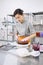 A bright pastry chef girl is engaged in the preparation of a cake